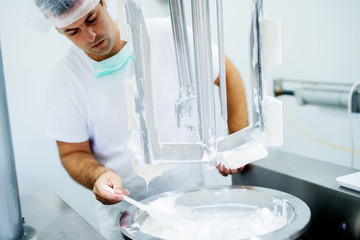 Young pharmacist formulating the chemical for cosmetic.