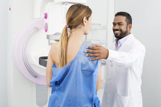 Doctor Preparing Patient For Mammogram Test