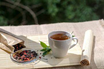 Cup of mint tea and a bunch of mint on the table