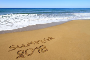 “Summer 2013” written on sandy beach