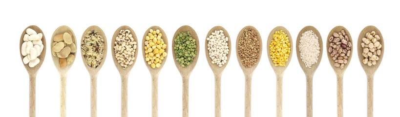 Variety of raw legumes and rices in spoons - white background