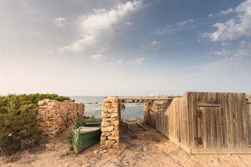 Old boat on the old pier of a fisherman on the island of Formentera. Spain