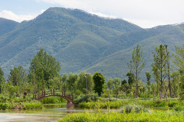 Mountain landscape with a wodden bridge in Xichang, China