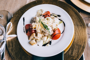 Chicken Caesar Salad. Caesar Salad with grilled chicken on plate. Grilled chicken breasts and fresh salad in plate