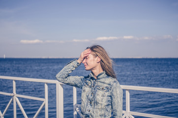 Fototapeta premium Woman with headache against the sea
