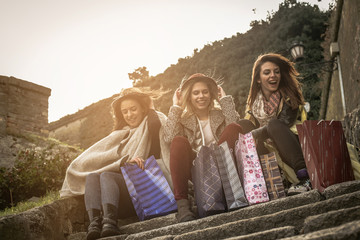 Three best friend after shopping. Three best friends roasting on the stairs after shopping having...