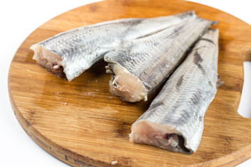 Fresh hake fish on the wooden board
