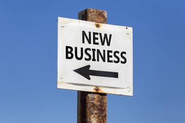 New business word and arrow signpost