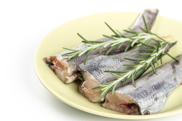 Hake fish on the plate with rosemary branches