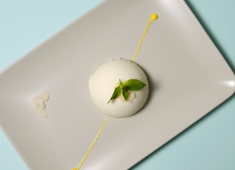 Panna cotta on a plate with almond petals