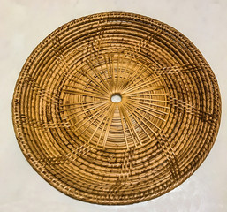 Empty bamboo rattan woven tray place mat on the white marble table background