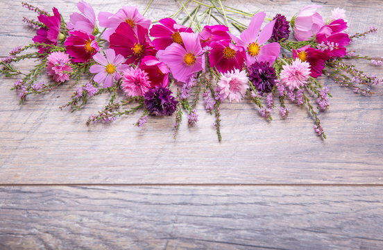Fototapeta Pink and purple flowers cosmea or cosmos and cornflowers on rustic wooden boards. Copy space. Mother's, Valentines, Women's, Wedding Day concept