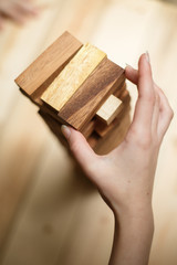 Planning strategy in business, businessman and engineer gambling placing wooden block on a tower.