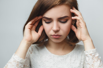 A young girl holds her hands behind her head, problems