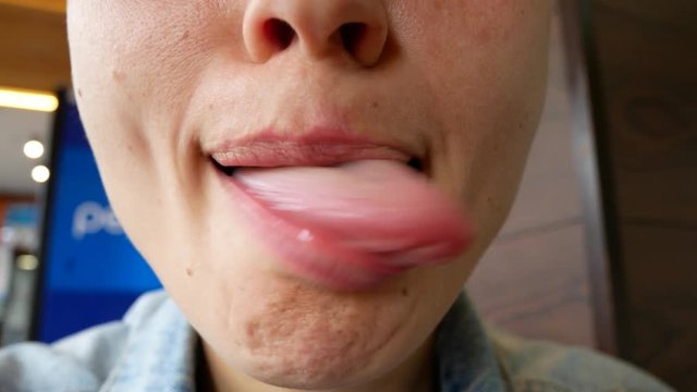 A close-up of the bottom of the female face. The girl makes a different grimace with her mouth.