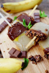 Homemade ice cream. Chocolate banana granola popsicles.