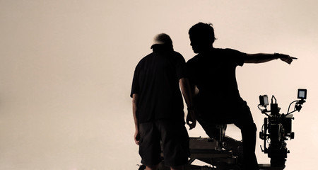 Silhouette behind the scenes of camera man.