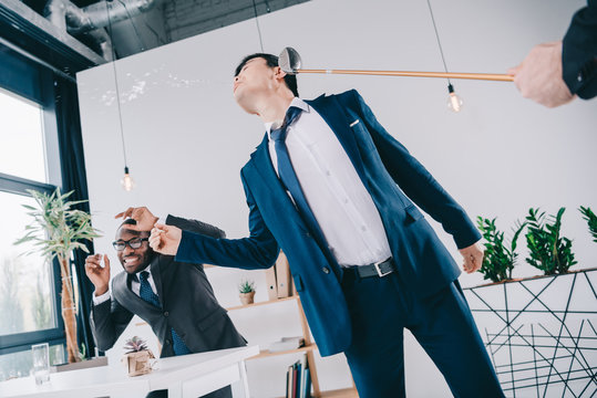 young asian businessman get hit with golf cub - Powered by Adobe