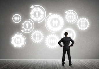 Cogwheel engine drawn on concrete wall as symbol for teamwork and cooperation
