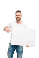 'Handsome bearded man holding blank banner and pointing on it, isolated on white