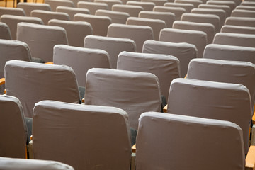 row of old grey seats in cinema