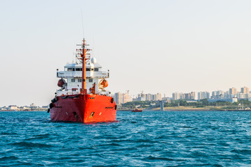 Fototapeta premium Cargo ship anchored in the roadstead Tsemes bay at the entrance of the port of Novorossiysk, Russia