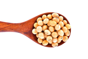 Soybeans in a wooden spoon on a white background