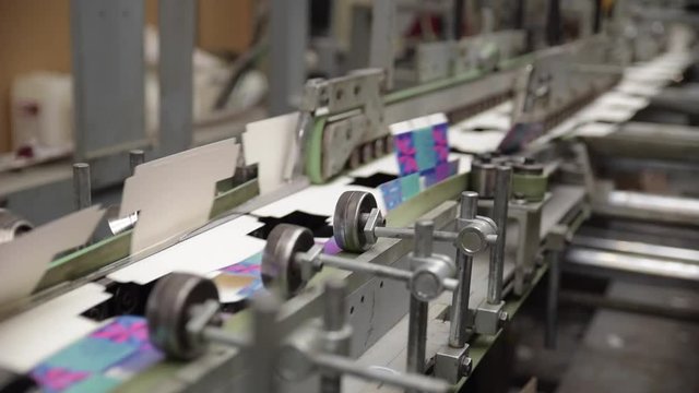 folding machine conveyor belt at print factory packaging production line