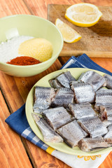 Sliced raw hake fish with mixture of flour paprika and corn flour