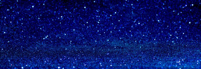 blue Sparkling Lights Festive background with texture. Abstract Christmas twinkled bright bokeh defocused and Falling stars. Winter Card or invitation. - obrazy, fototapety, plakaty