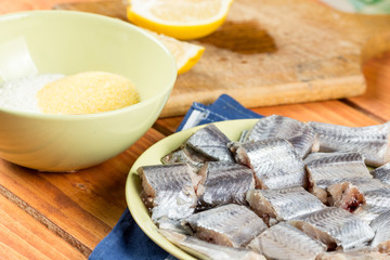 Hake fish with mixture of flour paprika and corn flour ready for frying