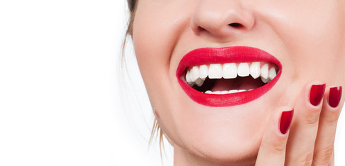 White teeth and red lips.  Perfect female smile after whitening teeth.