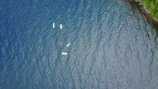 People on kayak aerial view from drone. People on vacation doing kayak activity