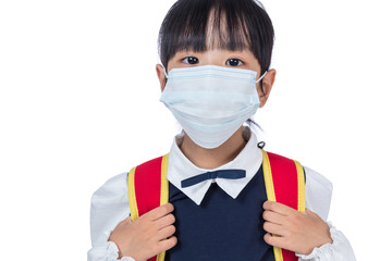 Asian Chinese school girl with school bag and wearing mask