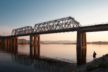 Fototapeta na wymiar Fishing under railroad bridge