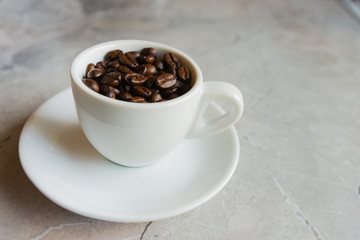 White Cup Filled With a Brown Coffee Beans