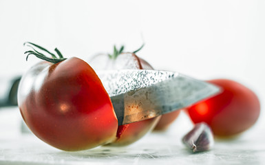 Roma tomato, garlic, forged knife, cutting