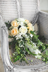 Wedding bouquet lying on a chair in a white Studio