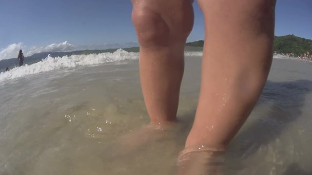 Baby / toddler / small child walking on the beach / sea. Feet close up. 4k.