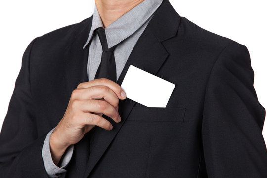 A Businessman takes a card out of his suit.