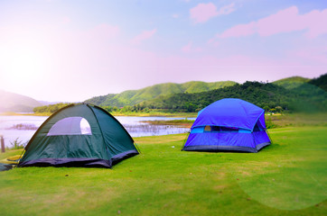 Camping Tent near mountain river in the summer, Sunrise in the morning