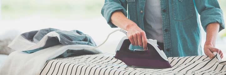 Woman ironing clothes - obrazy, fototapety, plakaty