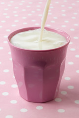 Pouring milk in pink cup - 167482262