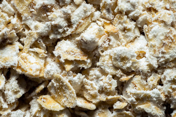 macro closeup of fine grinded whole grain oat flakes with lot of starches all around