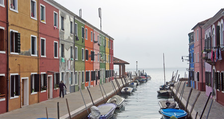 Fototapeta na wymiar Canal between houses on the island of Burano near Venice, Italy