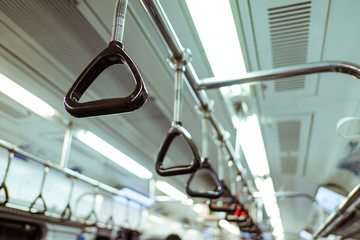 Handles on ceiling for standing passenger in a subway train