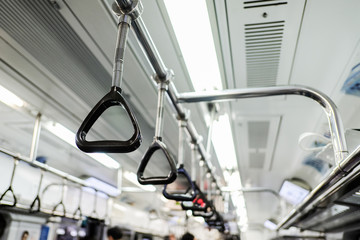 Handles on ceiling for standing passenger in a subway train