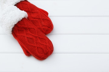 red mittens on wooden background