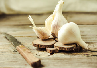 Organic garlic on a wooden rustic background, warm calm gamma.