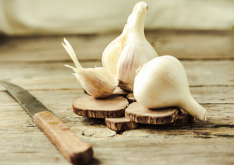 Organic garlic on a wooden rustic background, warm calm gamma.